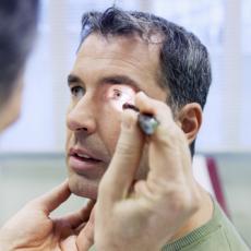 Image of Doctor Shining Light in Middle-Aged Man's Eye