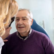 Elderly man being examined by a female optometrist