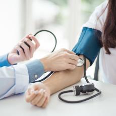 Doctor checks patients food pressure with stethoscope & blood pressure cuff