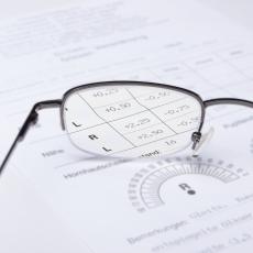 Glasses resting on top of a prescription for glasses
