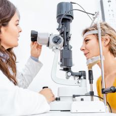 Ophthalmologist giving an examination of the eyes in ophthalmology clinic before LASIK surgery