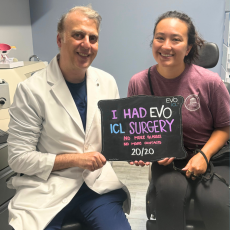 Dr. Silk and Patient together happy and smiling after surgery - patient is holding a sign that read they just had EVO ICL eye surgery.